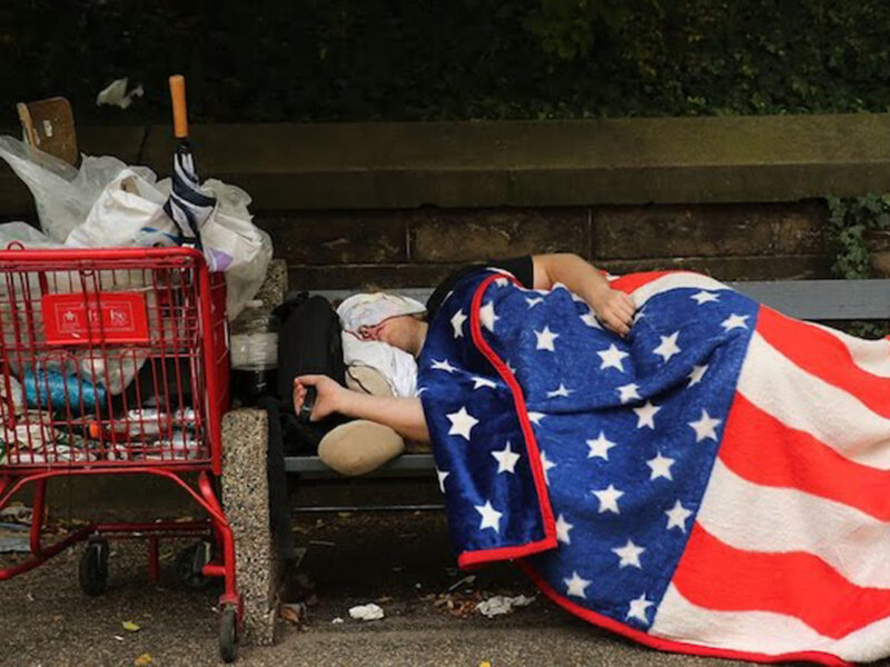 homeless woman sleeping on a park bench