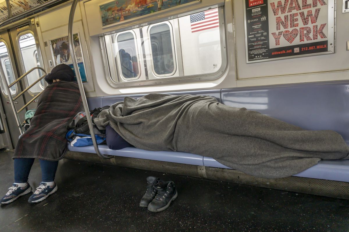 homeless people sleeping on subway